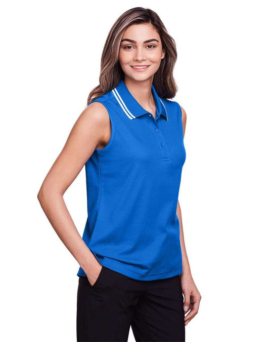 Devon & Jones DG20SW - CrownLux Performance® Polo sin mangas con ribete trenzado para damas