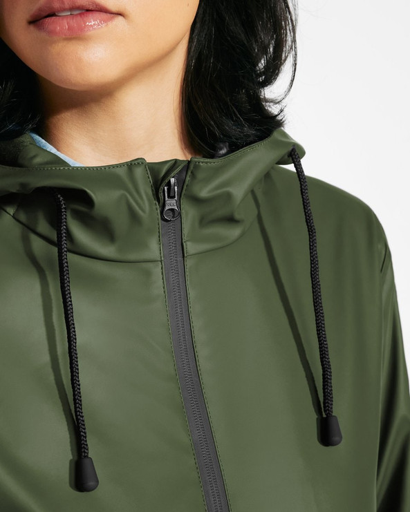 Roly CB5202 - SITKA WOMAN Waterproof raincoat with fixed hood and intergrated visor slightly fitted at the waist