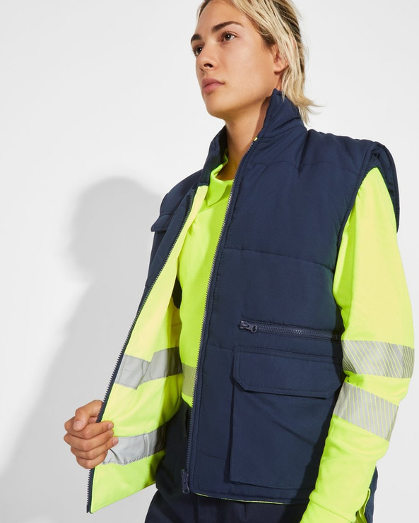 Roly HV9313 - PERSEI Reversible padded high-visibility multi-pocket vest with extended back