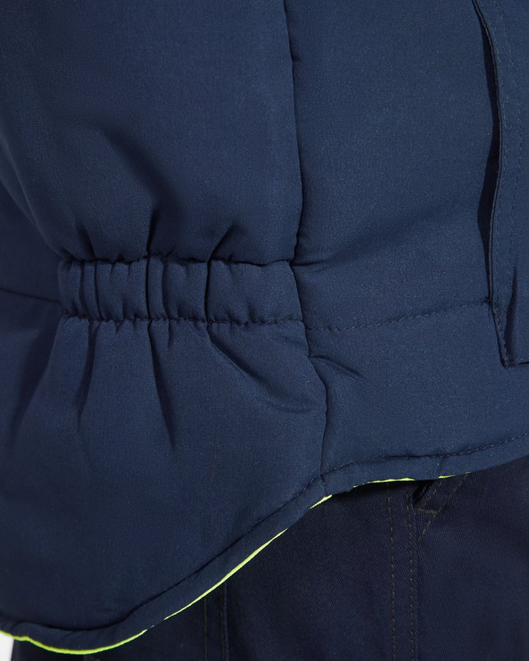 Roly HV9313 - PERSEI Reversible padded high-visibility multi-pocket vest with extended back