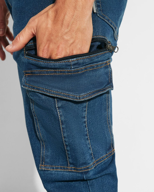 Roly PA8402 - RAPTOR Pantalon long en jean multi-poches avec coutures latérales légèrement sur le devant