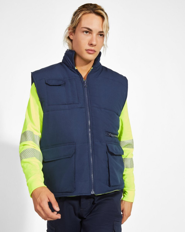 Roly HV9313 - PERSEI Reversible padded high-visibility multi-pocket vest with extended back